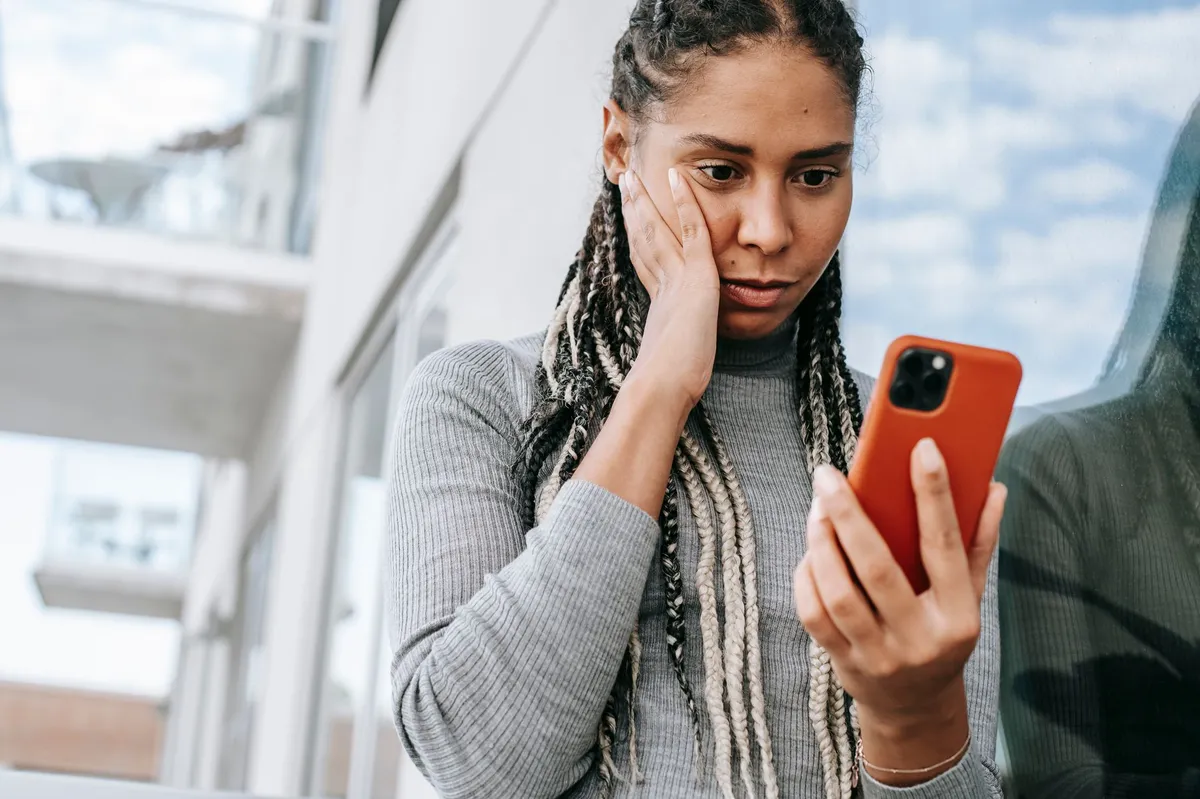 concerned woman looking at her phone