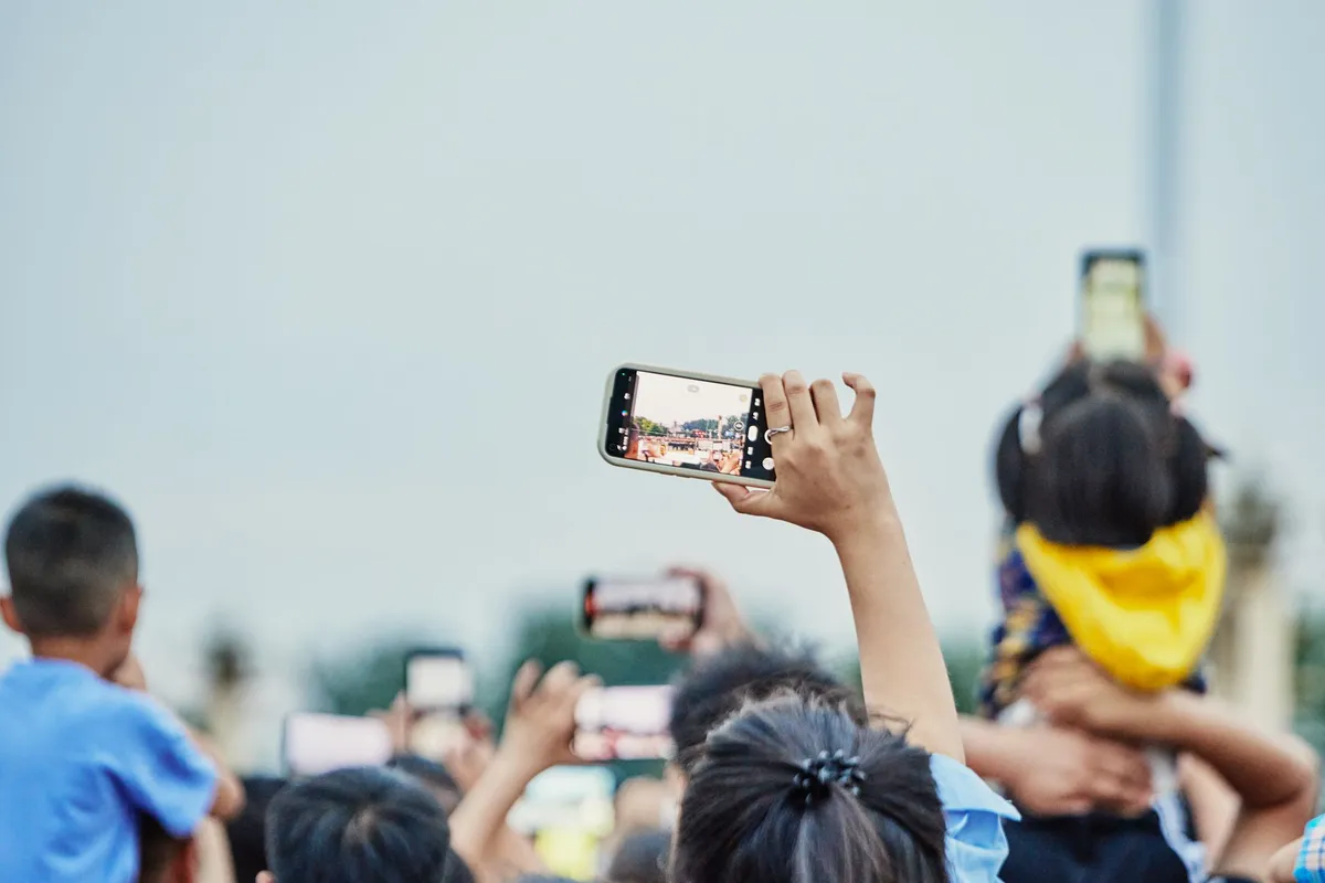 people using smartphones outdoors