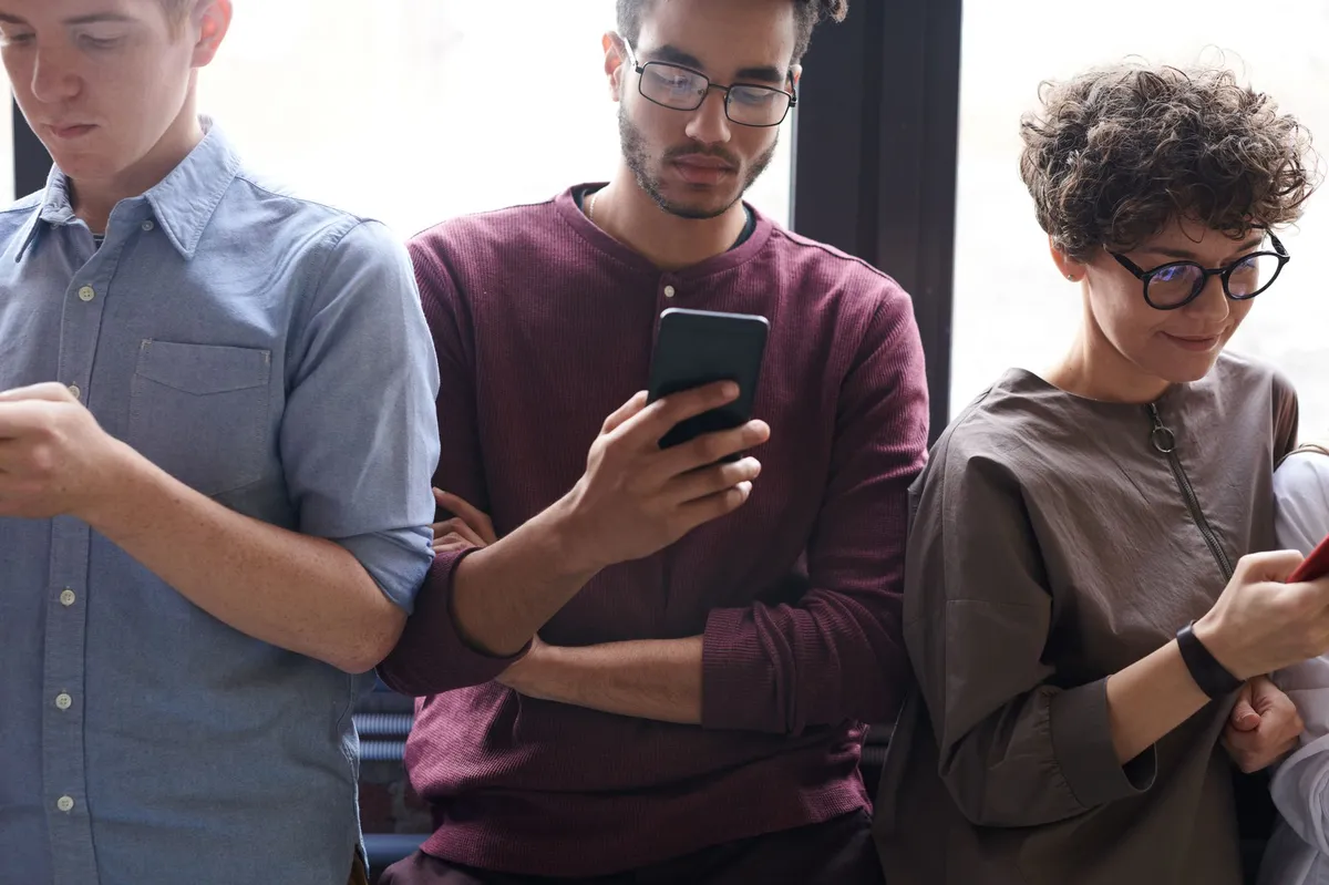 diverse group using smartphones