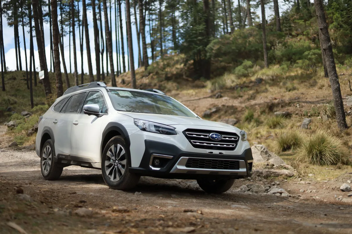 family loading gear into Subaru Outback