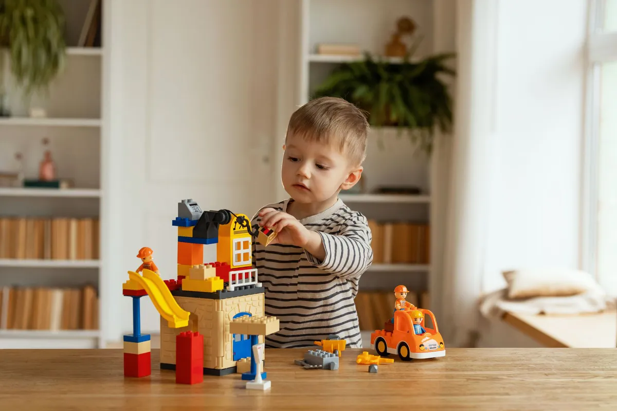 child building Lego model