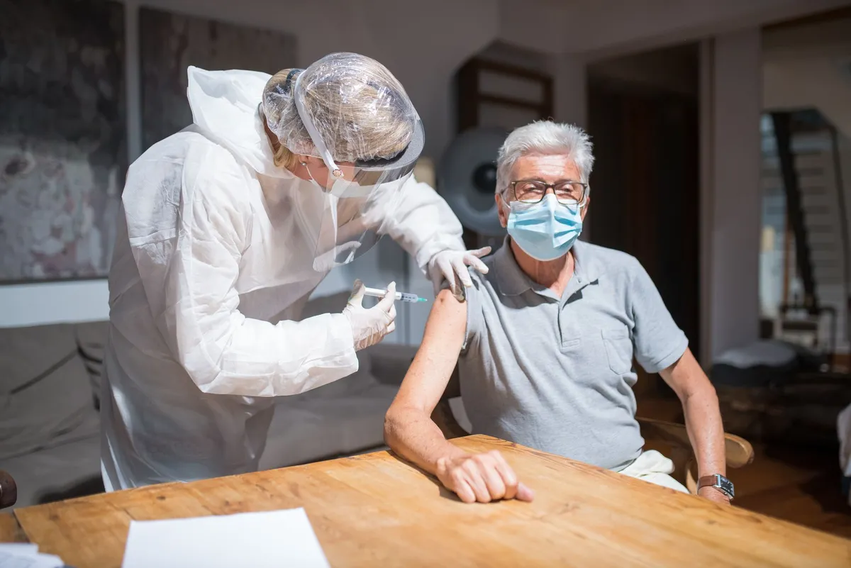 elderly person receiving vaccine