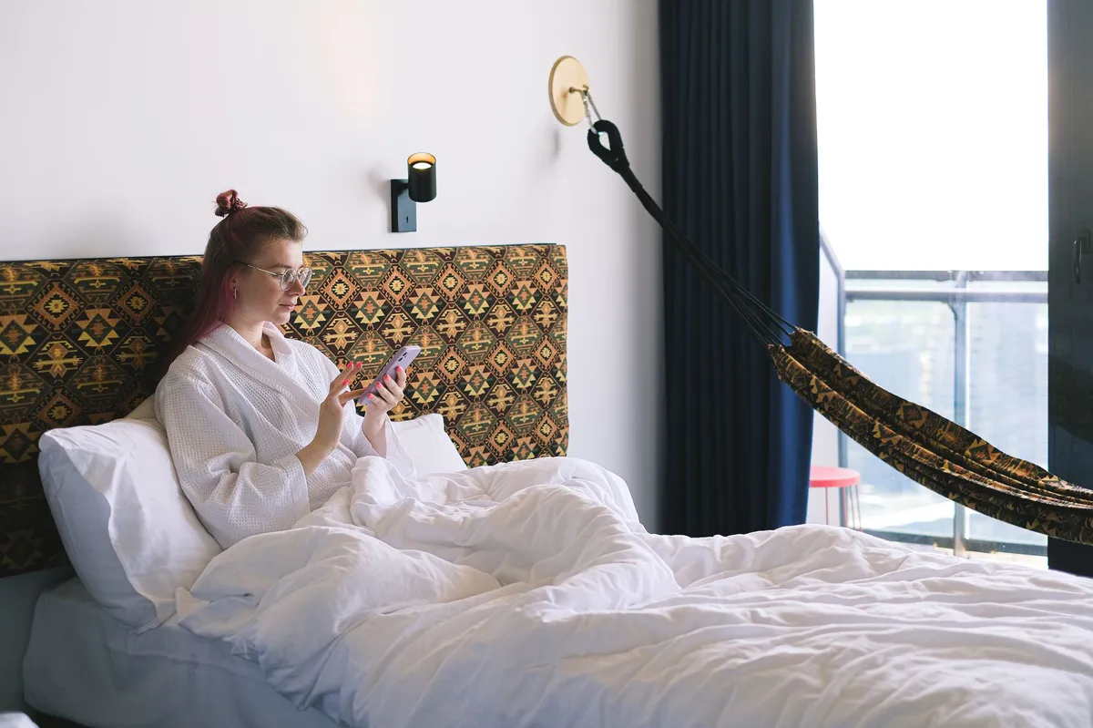 traveler using phone in hotel room