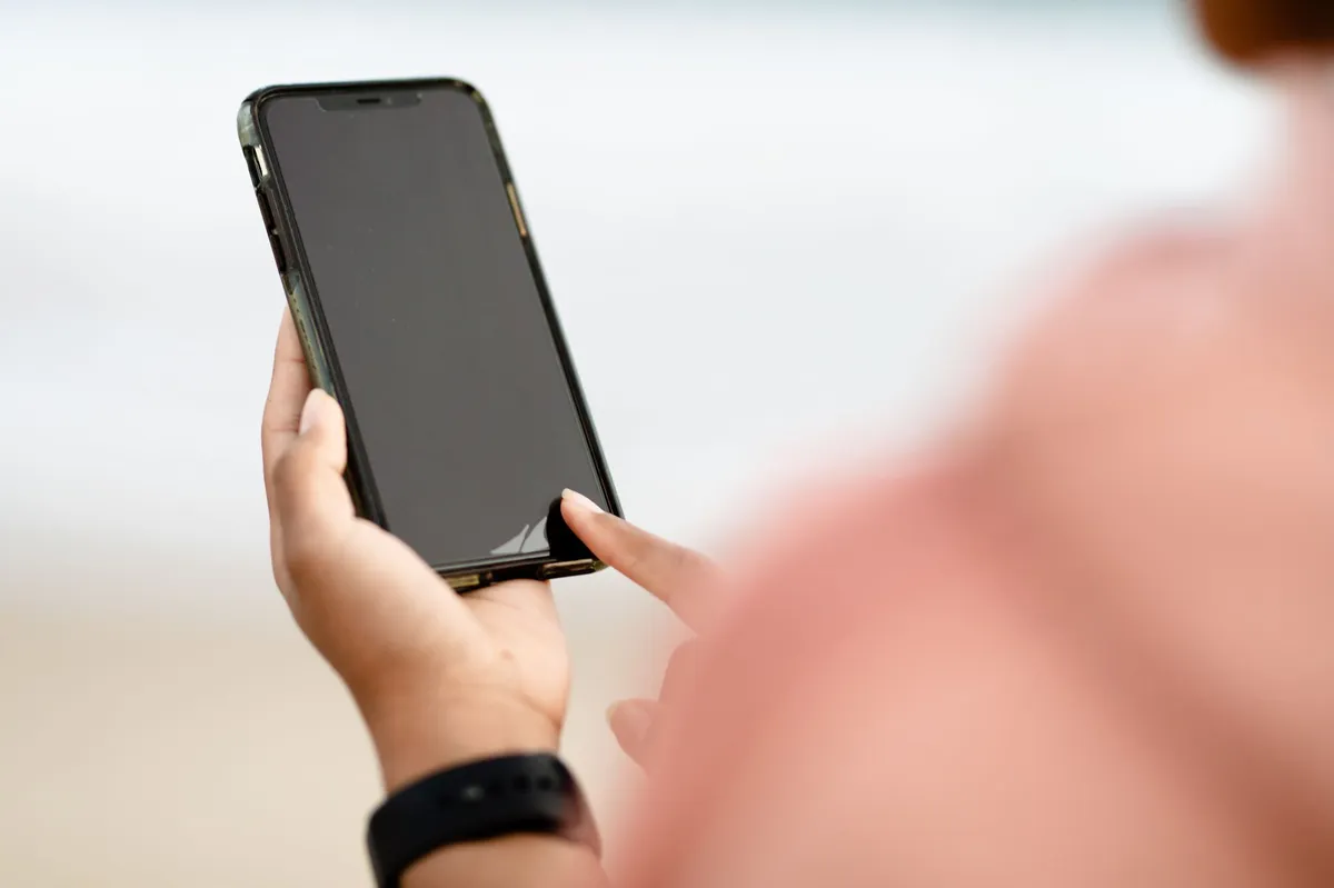 person using smartphone outdoors