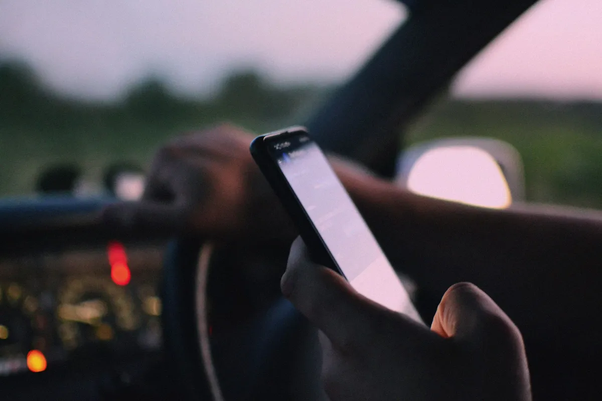 person using smartphone with distractions