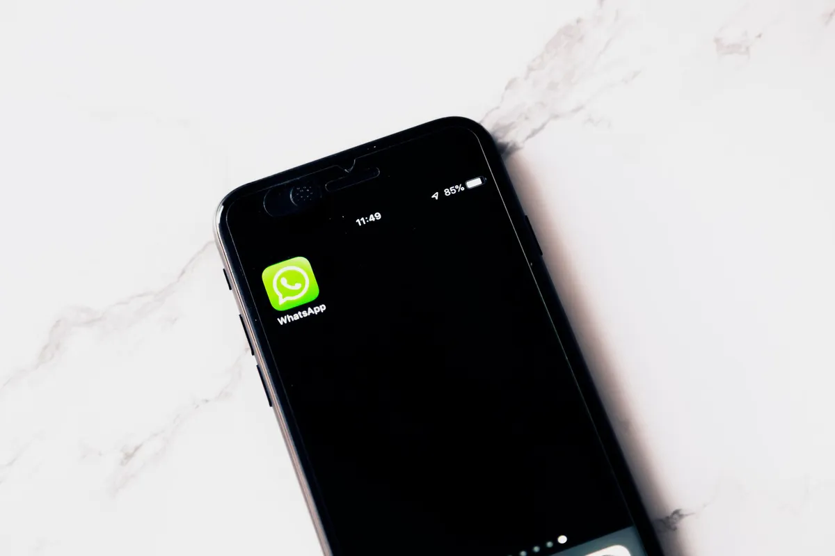 smartphone with WhatsApp on screen