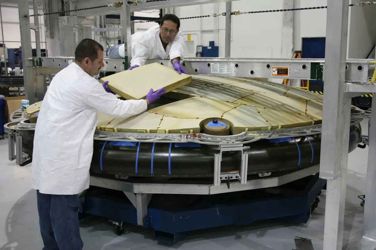 engineers analyzing spacecraft