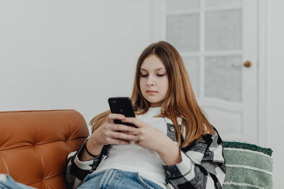 teenager using smartphone in car